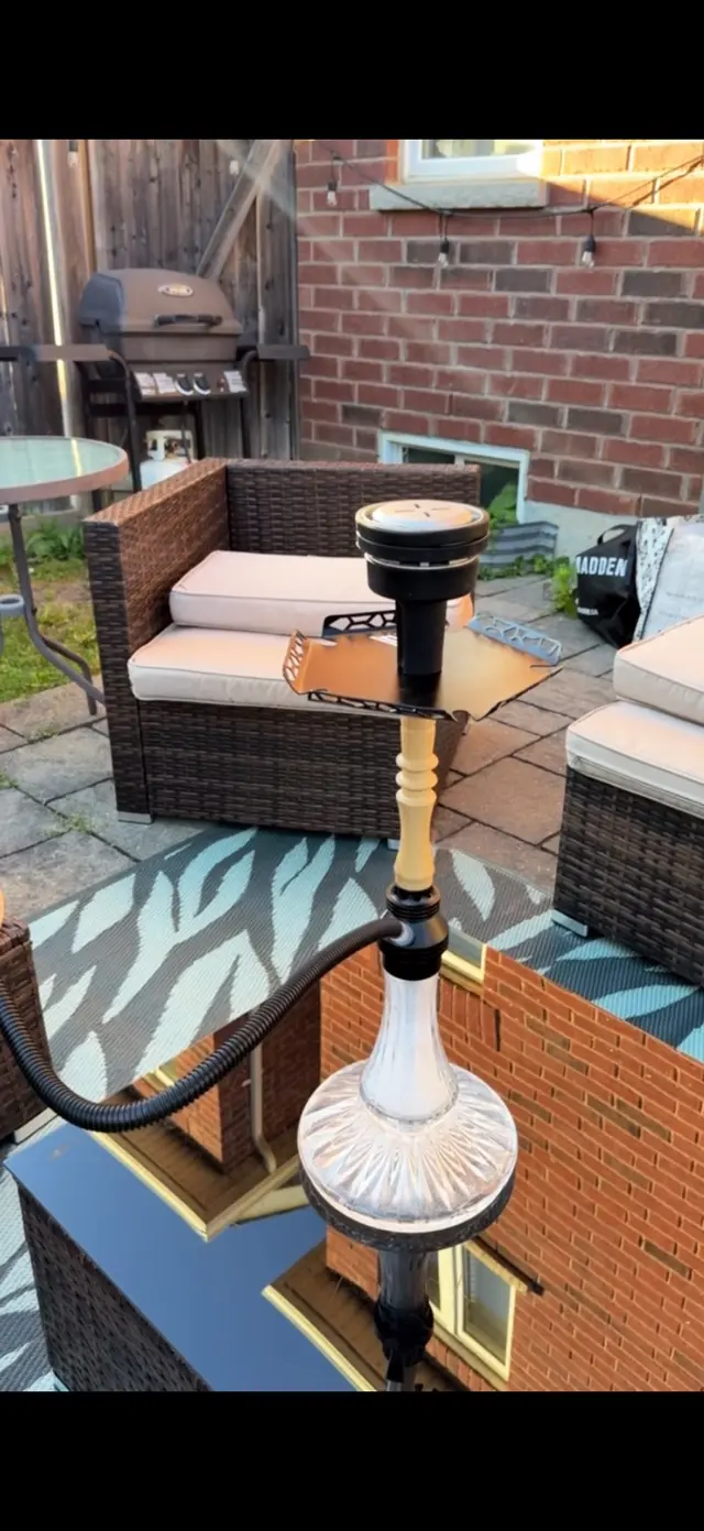 Hookah set up on a back patio beside outdoor seating