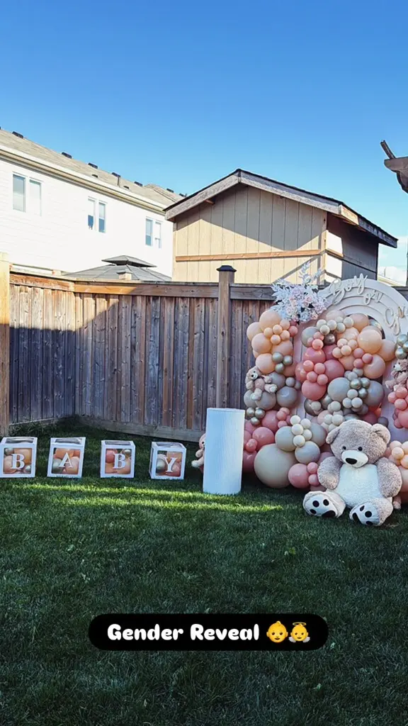 Backyard gender reveal — balloon arch, lawn games and the hookah setup alongside