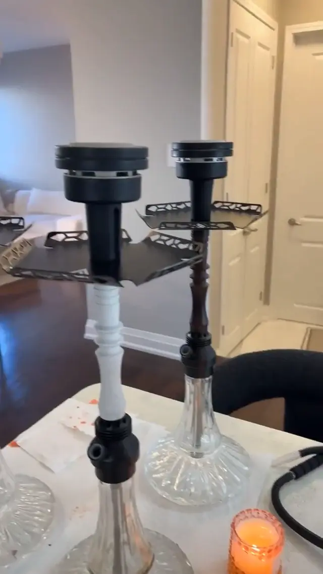 Two hookahs set up on a table indoors